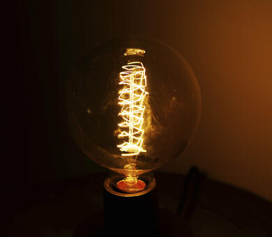 A glowing lightbulb in a dark room